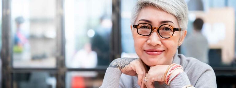 Woman wearing glasses and she has white hair. Internal Mentoring Certification