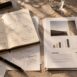 Notebook and reports with charts, notes and strategic planning on a desk.